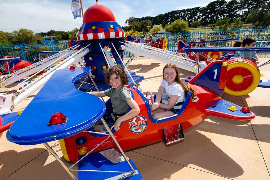 Kids on a miniature plane ride