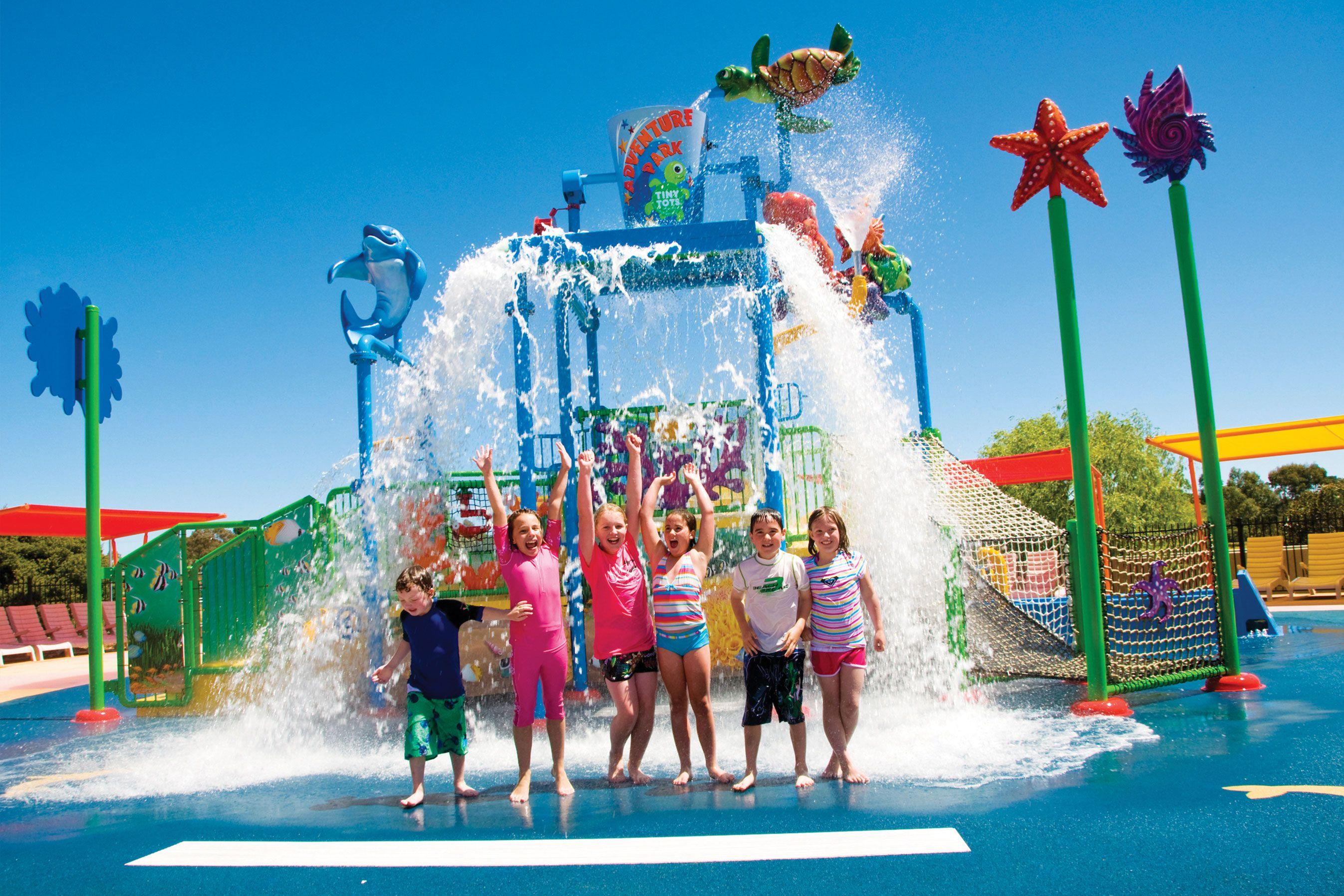 Little kids getting splashed on the Tiny Tots splash zone